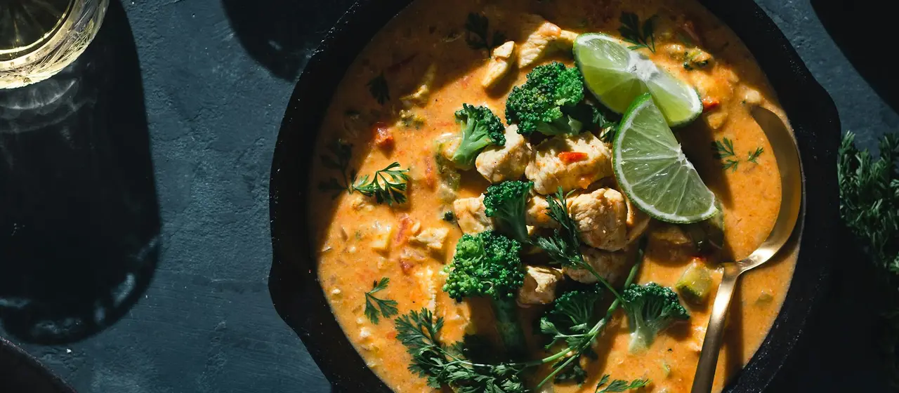 Thai curry and rice served in earthenware bowls