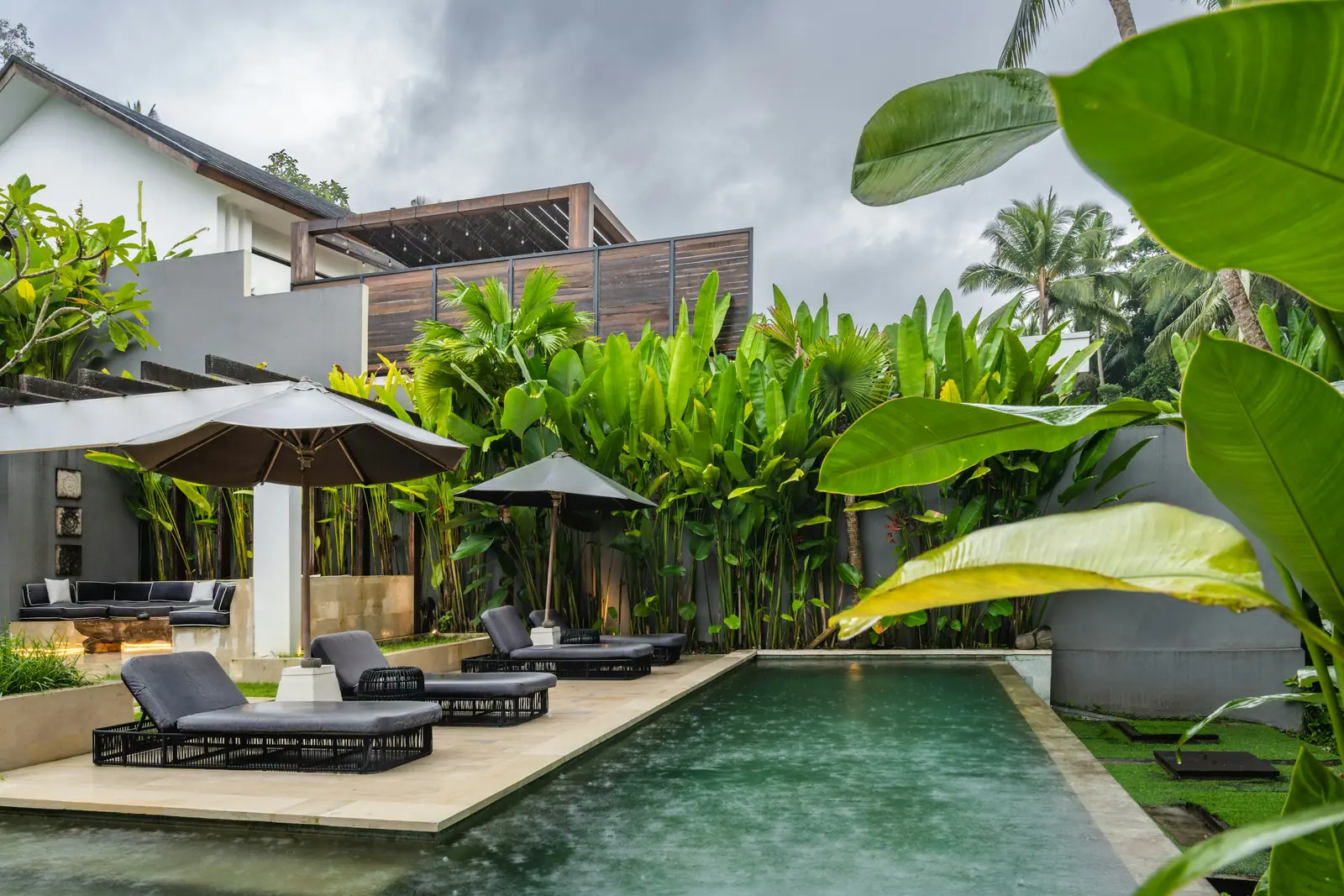 Loungers and a parasol beside the suite's private green-tiled plunge pool